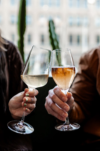 Couple sharing wine at Joui Wine Dayton, a cozy downtown Dayton date night spot.