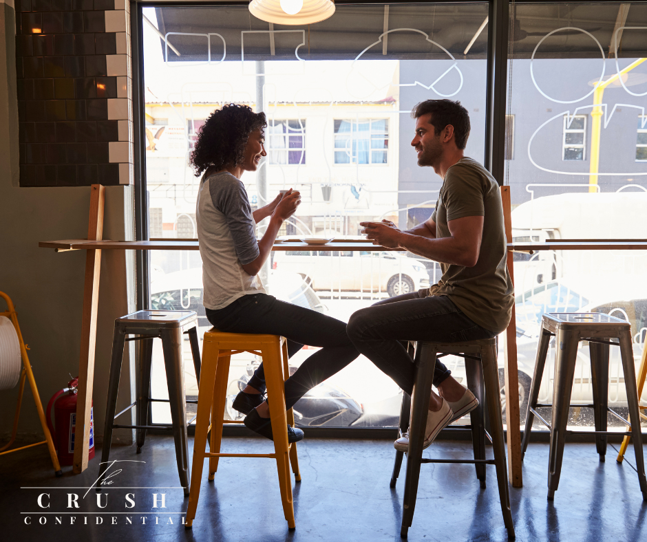Confident man on a first date smiling and making conversation, representing first date confidence for men.