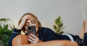 A person looking at phone bored.