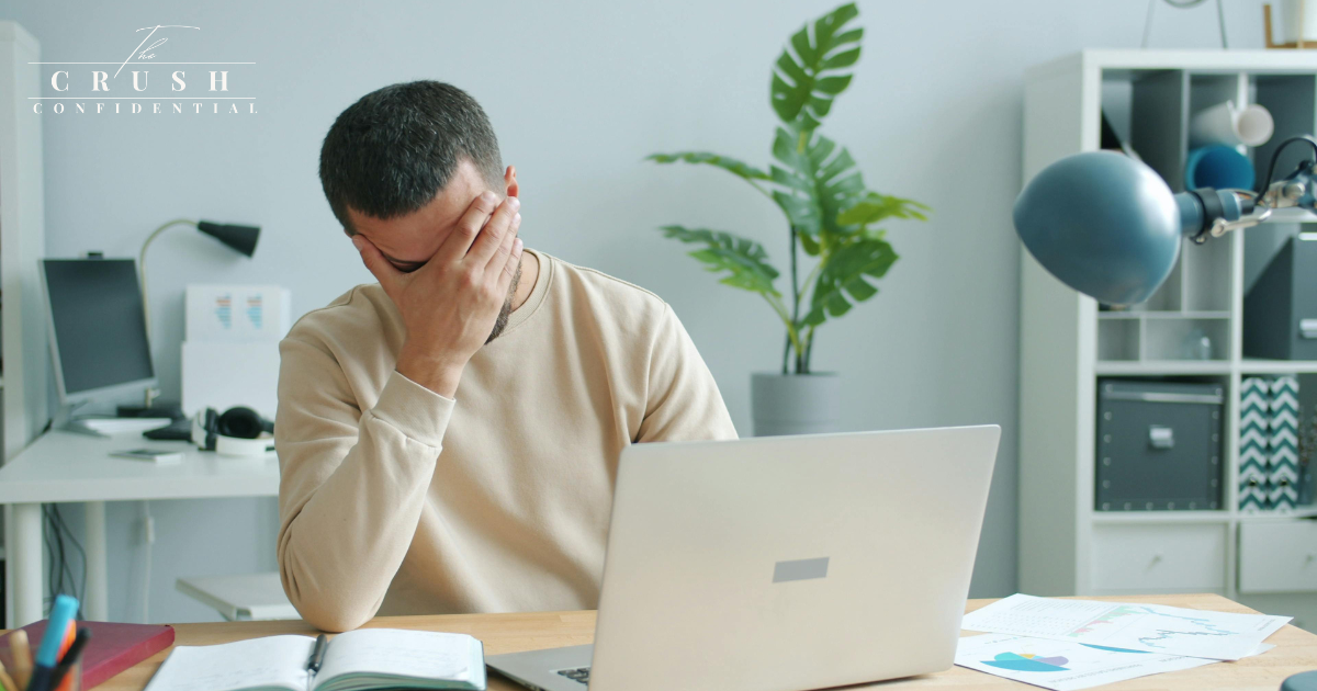 A man looking frustrated at computer.